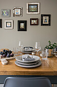 Place setting at table with framed photos in Guildford townhouse Surrey UK