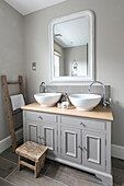Sleek modern bathroom with rustic French market finds in Guildford townhouse Surrey UK