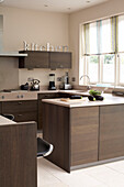 Kitchen with dark wood fitted units and lettering