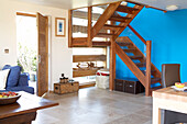 Blue feature wall and wooden staircase in Isle of White home