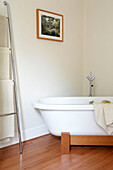Freestanding bath with metal towel rail in London home