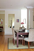 Dining room table with mirror giving sense of space in Sydney home Australia