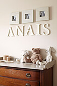 Artwork and lettering with soft toys and changing table in child's nursery of Sydney home Australia