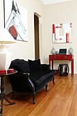 Black sofa and modern art in study of n Sydney home Australia