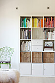 White storage unit and metalworked chair in Sydney apartment Australia