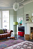 Spacious pastel green living room with modern fittings in Scottish apartment building UK
