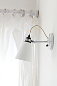 Wall mounted lamp and curtains in contemporary Weymouth beach house, Dorset, UK