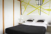 Abstract wallpaper in bedroom of contemporary Coombe home, England, UK