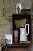 Gardening equipment and wooden crate in stone shed, St Lawrence, Isle of Wight, UK
