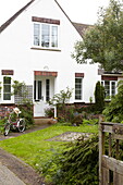 Bicycle on footpath of whitewashed home in Bembridge, Isle of Wight, UK
