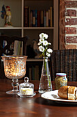 Lit candle with garlic bread and mustard on dining table in semi-detached home UK