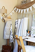 Bunting and rolls of fabric with dressmakers dummy in Wiltshire home, England, UK
