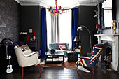 Union Jack and white leather armchairs in contemporary London living room with blue velvet curtains, England, UK