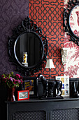 Equestrian statue and mirror with contrasting wallpapers in London home, England, UK