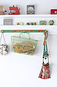 Vintage sewing objects on shelf storage above pegboard in Ryde home Isle of Wight, UK