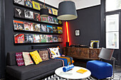 Record collection above sofa in black room of Hastings townhouse East Sussex England UK