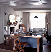 Open plan living room with panelled ceiling and desk