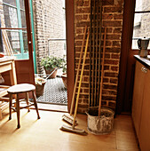 Broom and mop and bucket by kitchen door 