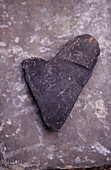 Heart shaped stone on granite rock