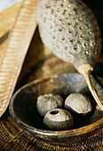 Detail of decorative African gourd and wooden bowl with seed pods