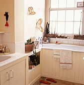 Rustic bathroom with cream painted decor and found natural objects on display