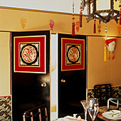 Decorative Chinese style black double doors in opulent dining room