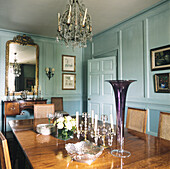 Elegant panelled dining room with antique glass vases
