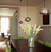 Dining room table with table lights and flower vase