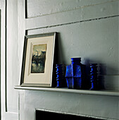Blue glass vases on mantlepiece