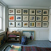 Bedroom wall filled with post war commercial art illustrations