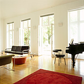 Bright airy living space with grand piano and modern classic furniture