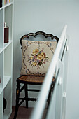 vintage dining chair with tapestry cushion cover set on a modern mezzanine