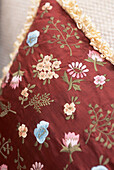 red oriental style floral embroidered cushion