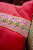 Geometric beaded trimming on pink cushion
