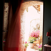 Back door to courtyard with curtain blowing in the breeze