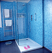 Walk in shower in modern blue mosaic bathroom