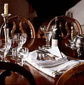 Vintage tableware and glasses displayed on a mahogany tabletop