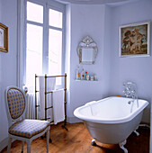 Roll top bath in white painted bathroom