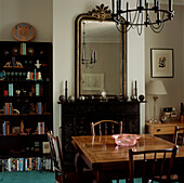 open shelving display in a rustic style Victorian dining room with large mirror on a mantelpiece