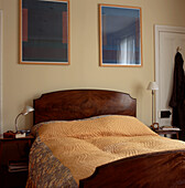 bedroom with Mahogany headboard with yellow quilt bedspread