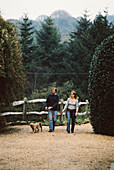 Couple walking dogs in the country 