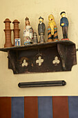 Detail of small figurines and maritime memorabilia on vintage shelf in the kitchen