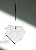 Glass love heart hanging on string