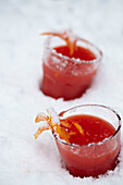 Glasses of blood orange juice in the snow
