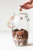 Person saving coppers in a jar