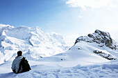 Man sitting on mountainside in Zermatt, Valais, Switzerland
