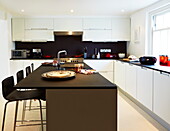 Contemporary dark wood kitchen in London townhouse, England, UK