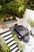 Elevated view of courtyard garden table and terrace, London, England, UK