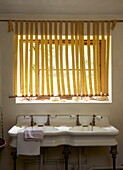 Window blinds above ceramic double sink in Cumbria home, England, UK