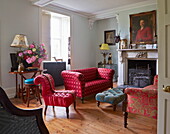 Upholstered furniture in wood floored living room of Cumbrian farmhouse, England, UK